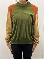 Front view of sweater on model showing color block and fit