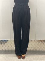 Front view of high-waisted black cashmere trousers on mannequin