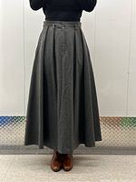 Front view of grey wool full skirt with fitted waistband and pleats