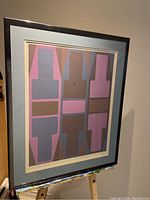 Frontal view of framed print on easel