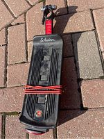 Top view of the black alloy bike rack with rubber straps and Schwinn logo.