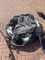Thule Tahoe 867 soft carrier bag shown unfolded and partially collapsed on the ground with visible Thule logo