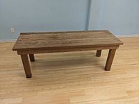 Full front and side view of the cedar bench showing wood grain and structure.