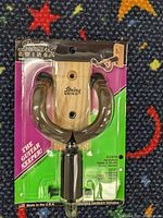 Close-up photo of a single String Swing CC01K guitar hanger in original packaging, showing the cushioned horseshoe hook and wooden mounting block.