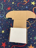 White corrugated cardboard mailing box, partially unfolded showing inner flaps and base.