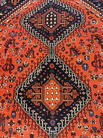 Close-up of central geometric medallion on red field