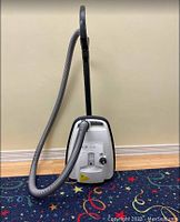 SEBO Airbelt K2 canister vacuum with hose and wand attached, floor tool facing the viewer