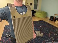 Person wearing the Zydeco washboard strapped on torso showing size and shape