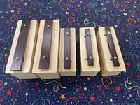 Top-down view of all five contrabass chime bars arranged side by side