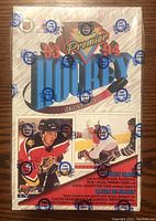 Front view of factory sealed box showing OPC Premier branding and hockey player images