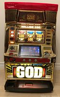Front view of the full-size slot machine showing illuminated canopy, reels and payout tray