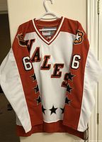 Front view of vintage CCM hockey jersey with 'WALES' text, number 66, star motifs, and NHL badge on shoulder.
