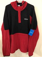 Full view of men's Columbia fleece hoodie in red and black, hung on a hanger.