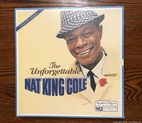 Front cover of the Collector's Edition vinyl record album showing Nat King Cole in a white coat and checkered hat.
