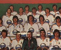 Close-up image focusing on the signed team photo on the card, showing players in Buffalo Sabres uniforms.