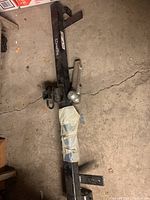 Overall view of Draw-Tite trailer hitch bar with ball mount wrapped in tape, showing hardware and brand label.