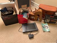Full lot including Polaroid camera in box, Brownie movie camera with case and box, digital photo frame and manuals