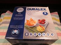 Front of Duralex box showing brand, series Lys, 9-piece set, and design of clear glass bowls with food.