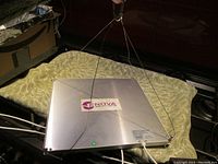 LED grow panel light hanging with visible Nova Solutions label on silver metal casing.