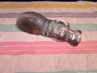 Top view of the glass hippo figurine showing the rounded hippo head and textured body.