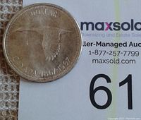 Obverse of the 1967 Canada silver dollar showing a flying goose and inscriptions.