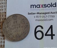 Front side of the 1911 Canadian 50 cents coin showing denomination, date, maple leaves, and royal crown.