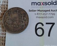 Reverse side of 1944 Canadian silver half-dollar showing Canadian coat of arms and denomination