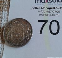 Reverse of 1950 Canadian half-dollar with Canadian coat of arms, crown, denomination and date