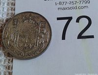 Reverse side of the 1952 Canadian half-dollar coin showing the detailed crowned shield of Canada with '50 CENTS CANADA 1952' inscription.