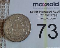 Reverse side of 1958 Canadian half-dollar coin displaying the Canadian coat of arms, denomination '50 CENTS', and year '1958'.