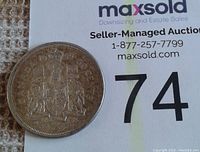 Photo of the reverse side showing the Canadian coat of arms and the date 1959.