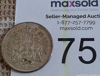 Obverse side of 1960 Canadian silver half-dollar coin showing crowned Canadian coat of arms, year and denomination.