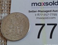 Photo of the reverse side showing the Canadian coat of arms and the 1962 date with denomination 50 cents.