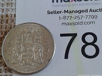 Reverse side of 1963 Canadian silver half dollar coin showing the Canadian Coat of Arms and denomination details.