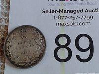 Reverse side of 1912 Canada 25 Cents silver coin showing denomination, country, date, and maple leaf wreath.