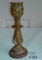 Front view of onyx candle holder showing twisted design and natural stone pattern.