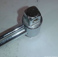 Close-up of square drive end of the torque wrench, showing chrome finish and socket attachment point.