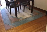 Full view of rug under dining table, showing overall pattern and dimensions