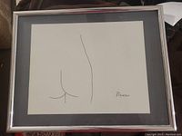 Framed Picasso print showing minimalist line art with signature in bottom right.
