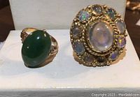 Both rings displayed side by side on white stand