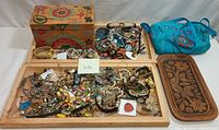 Overview of the costume jewelry and miscellaneous items including wooden trays and box visible but not included.