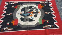 Detailed close-up of central bird and surrounding patterns on the blanket.