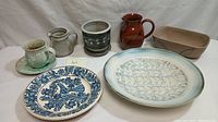 Photo showing entire lot of studio art pottery including planter, large dish, bowl, pitchers, cup and saucer