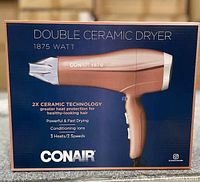 Conair Double Ceramic hairdryer packaging showing product image, branding, and key features of 1875 watt power, 2x ceramic technology, and heat/speed settings.