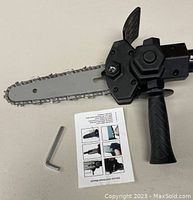 Photo showing the full 6-inch chainsaw attachment with blade, chain, main handle, and included Allen wrench and instruction sheet.