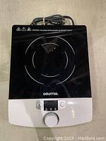 Top view of the Gourmia induction cooker showing the black crystalline composite surface and control dial.
