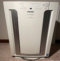 Front view of Electrolux Oxygen3 air purifier showing control panel and front face with silver vertical accents.