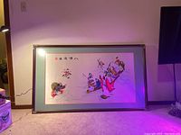 Full view of the framed Chinese embroidery artwork showing the complete scene of figures on boats and frame details.