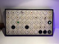 Full view of gemstone collection in tray with all stones arranged individually in clear plastic capsules.