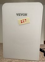 Closed front view of white Vevor mini fridge with a sticker '227' on front door.